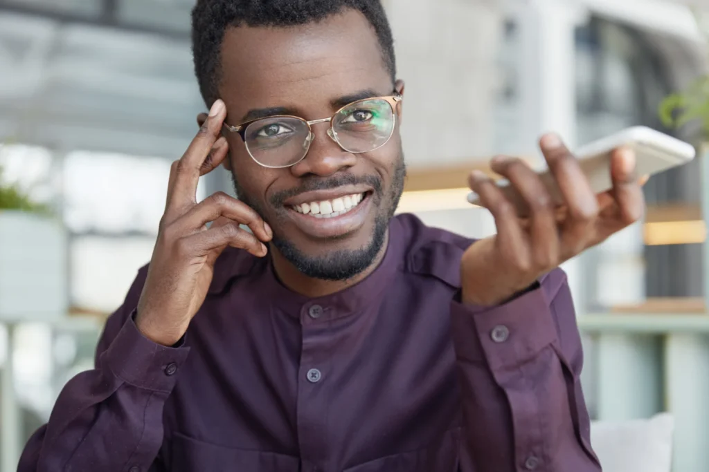 Cheerful young man confirming a payment in his banking app